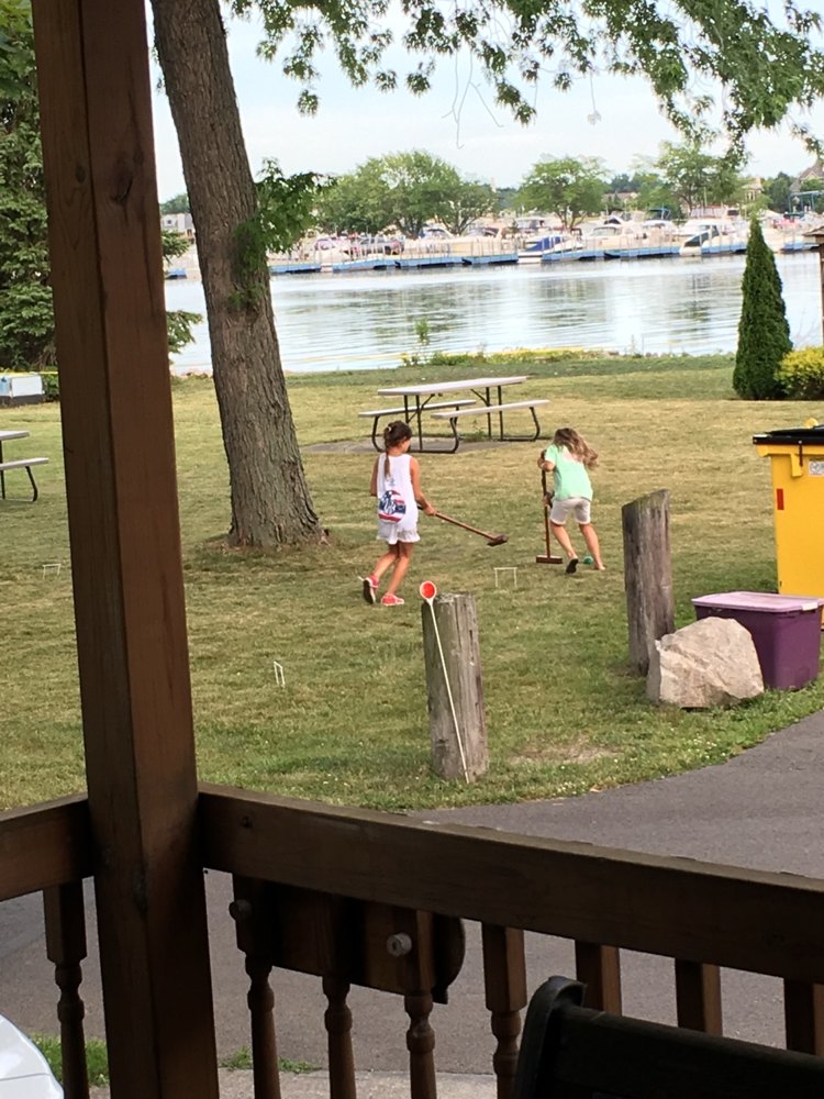 Croquet on the lawn at West Harbor Club, seen from the porch — the marina and harbor beyond