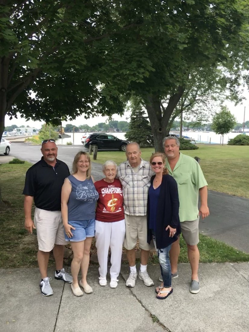 The Tibboles family gathered under the trees at West Harbor Club with the harbor behind them